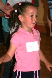 A little girl concentrates on the song and dance at the Ballysillan project.